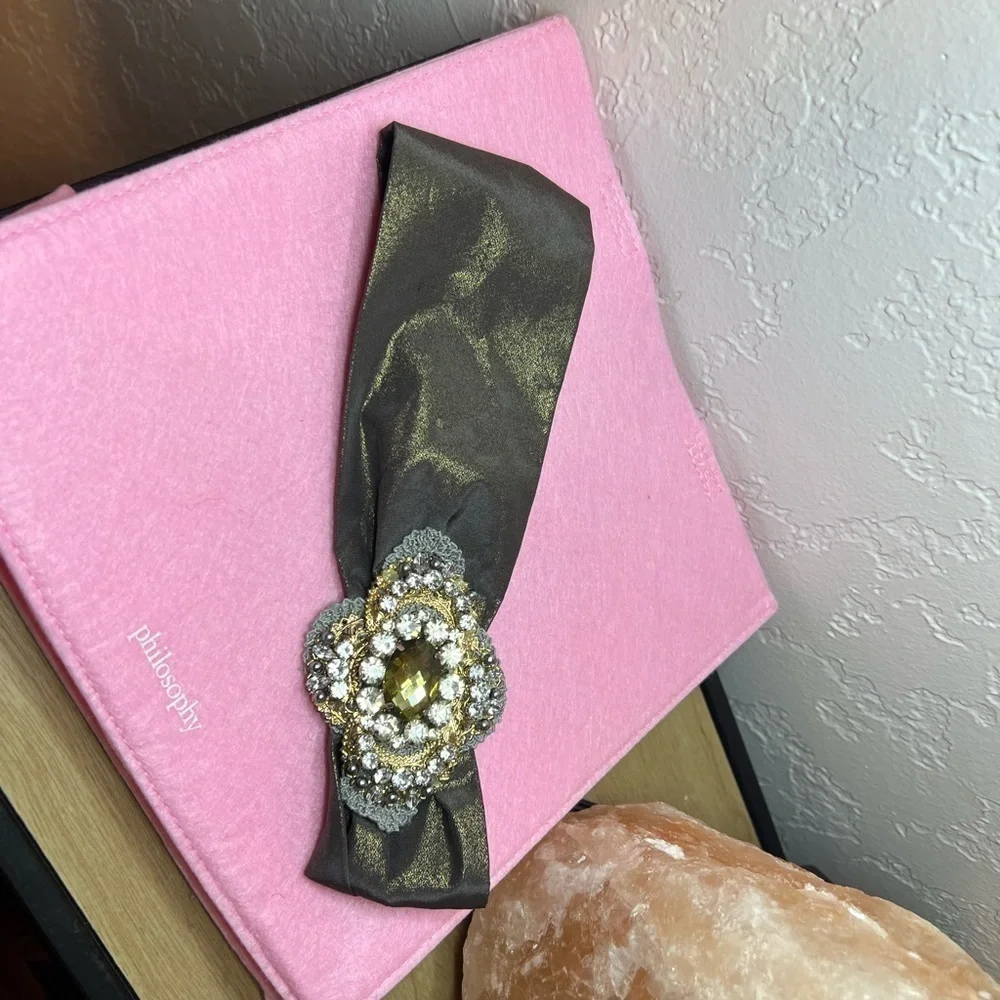 Headband, sparkling fabric and stunning brooch
